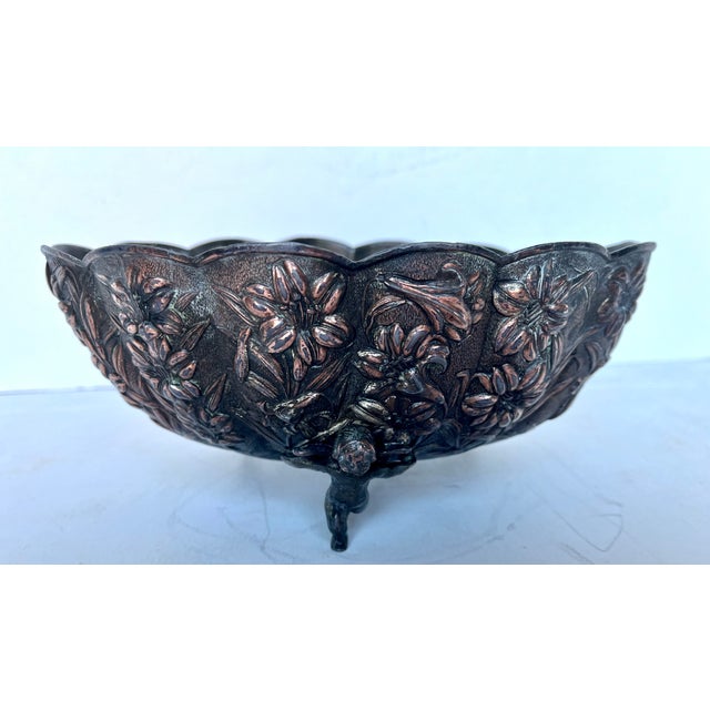 Vintage copper footed bowl. Embossed floral design. Scalloped edge. Three cherubs serve as the feet for this decorative...