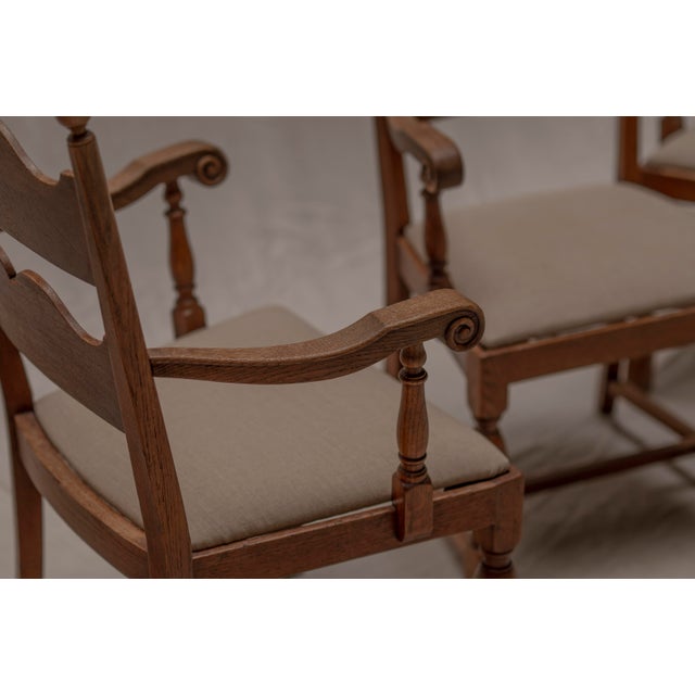 Charming set of four French mid-century dining chairs influenced by the work of Charles Dudouyt, crafted in solid oak with...