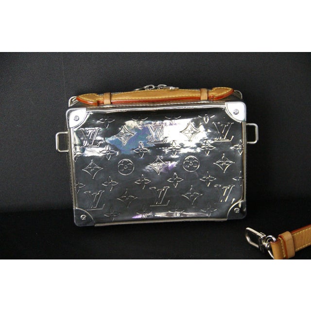 This Louis Vuitton Silver Mirror bag, designed by Virgil Abloh, is an extremely rare and limited edition. It is crafted...