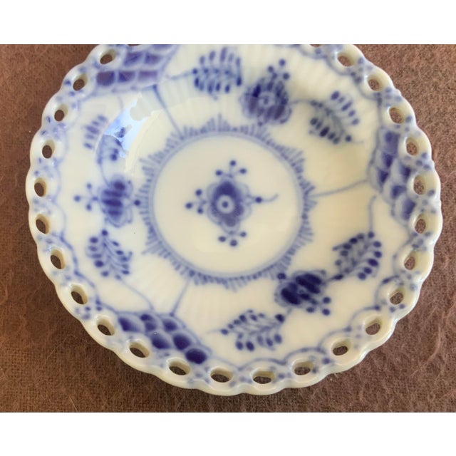 Discontinued item features iconic hand painted floral motif and open work pierced border. Designed as a butter pat dish...