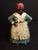 This authentic early 20th-century cast iron doorstop depicts a traditional domestic African American woman figure rendered...