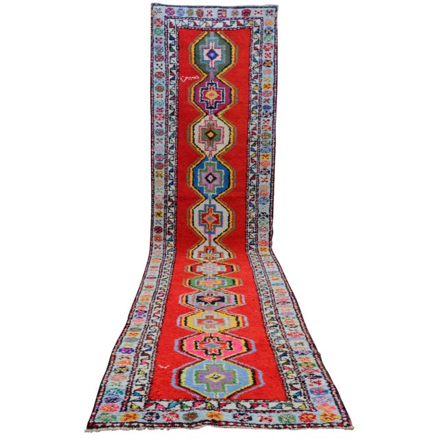 Woven in Southeastern Anatolia during the 1980s, this vibrant hand-knotted runner rug captures the energetic spirit and...