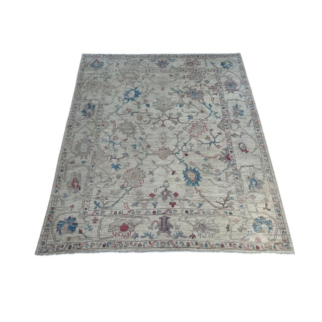 Allover angular floral design with large palmettes, serrated leaves and slender vine tracery drawn loosely across an open...