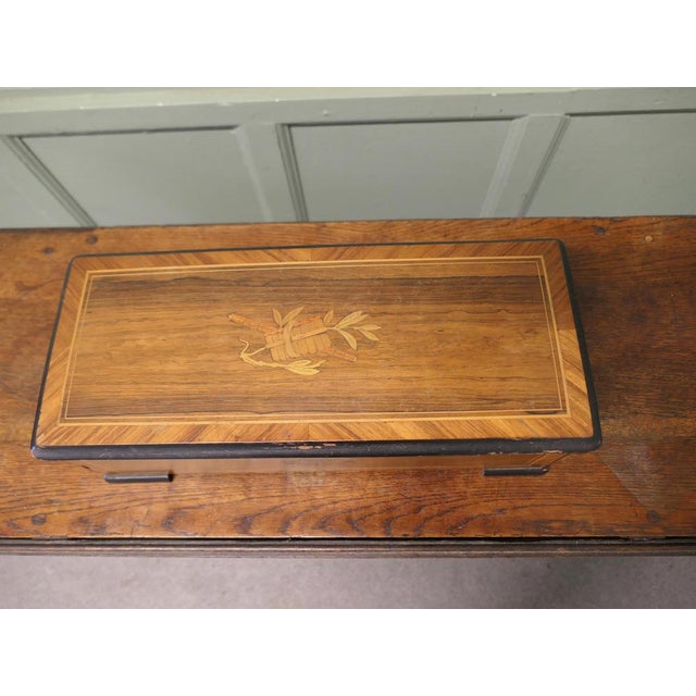 Victorian Musical Box A cylinder Music Box with a marquetry musical design on the top, when open this reveals a glazed...