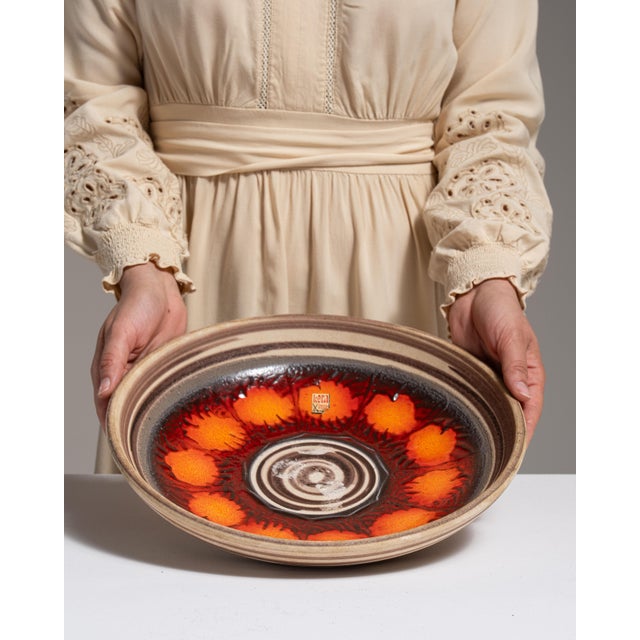 This 1960s serving bowl from Germany is finished in tan, worked in ceramic. Its form follows honest, well-proportioned...