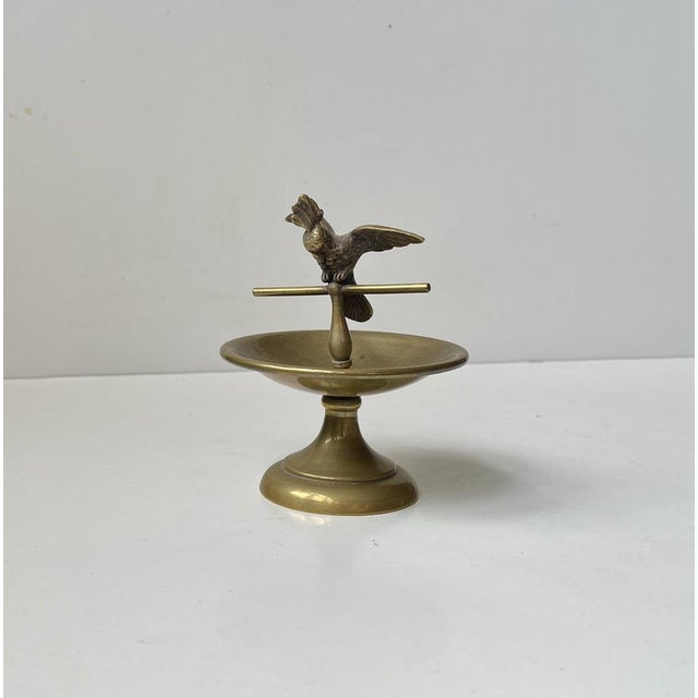 Art deco period ring or jewelry brass dish guarded by a small bronze cockatoo. Unknown Austrian/Vienna maker circa...