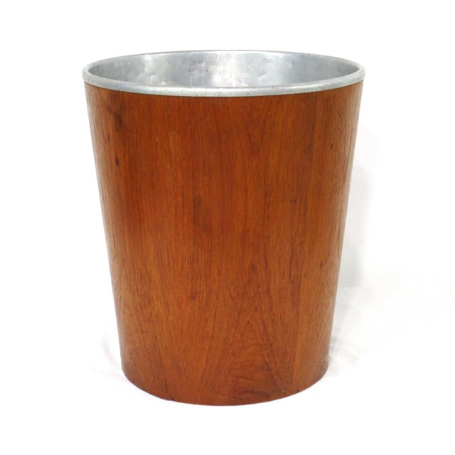 A nice functional and well- designed teak waste basket with removable aluminum liner perfect for your office, bathroom or...