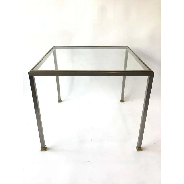 Purchased in Bloomingdales in the 1980s. Steel and brass side table with glass top.