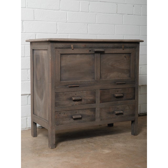 This antique wooden drawer chest from India showcases the warmth, character, and craftsmanship of early 20th-century...