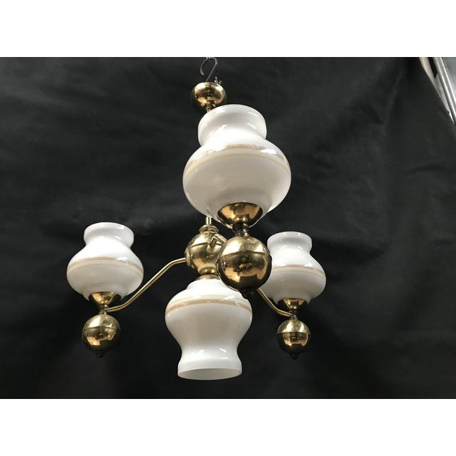 Gold chrome chandelier and glass from the 1970s Made of glass lampshades and a frame made of gold-colored chrome metal....