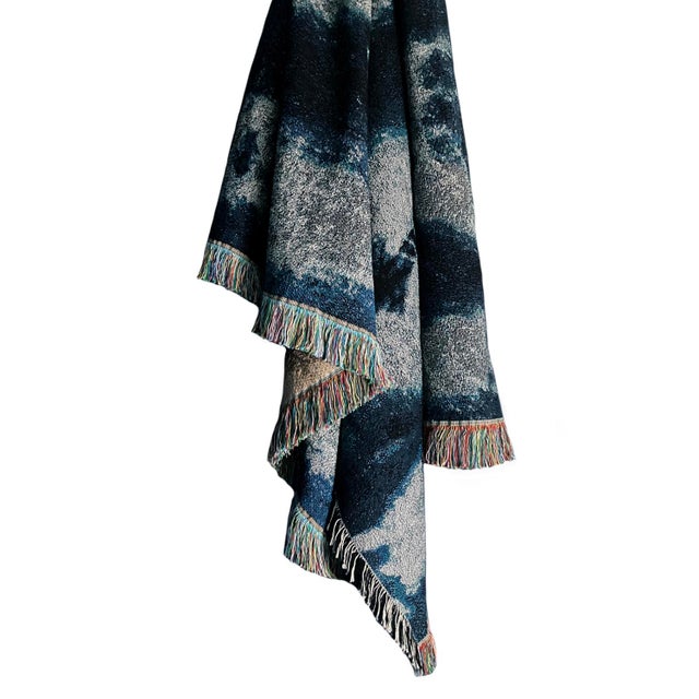 Silver gray and indigo blue jacquard woven throw with fringed edges. Woven with recycled cotton on a jacquard loom, made...