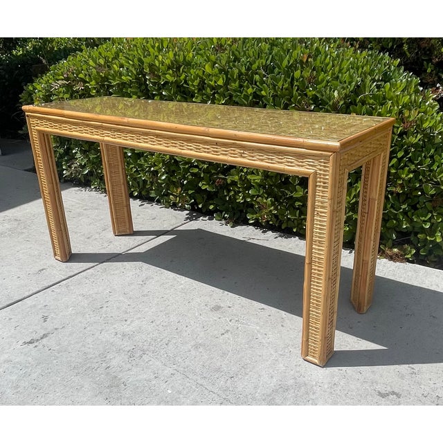 Vintage wicker console table! It features a Parsons shape design with woven rattan on all sides, legs witha rattan frame....