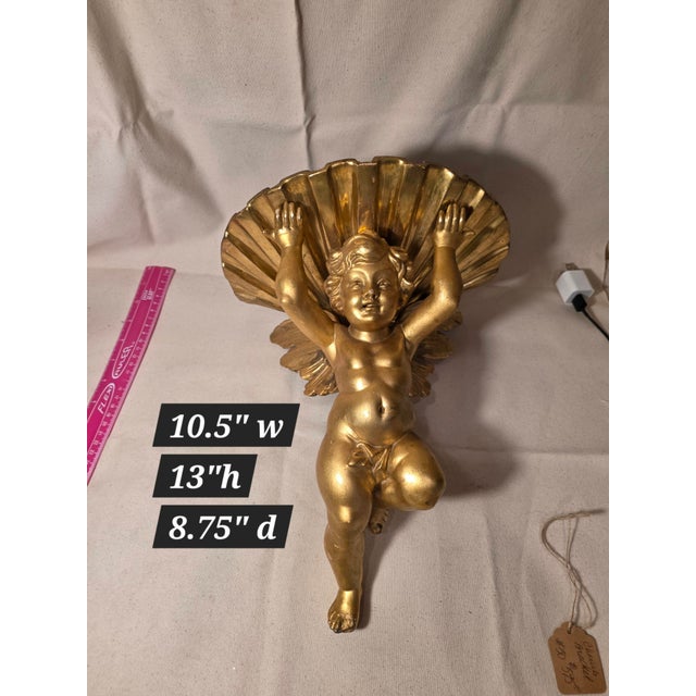 Beautiful antique giltwood cherub and shell form bracket.
