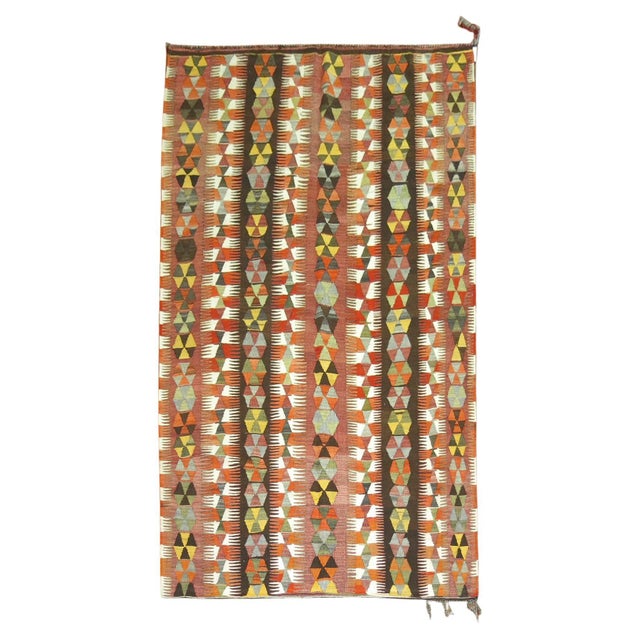 Mid 20th century Turkish Kilim with an all-over tribal design Measures: 5'7'' x 9'6''.