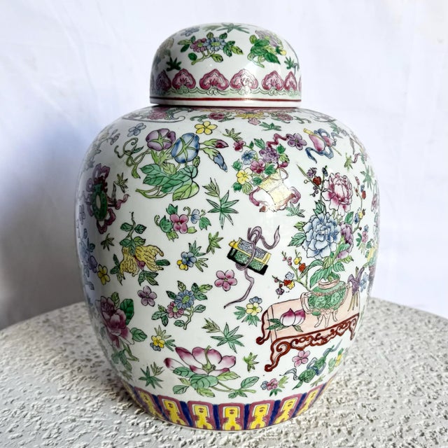 A stunning example of traditional Chinese artistry, this hand-painted porcelain ginger jar features a vibrant palette of...
