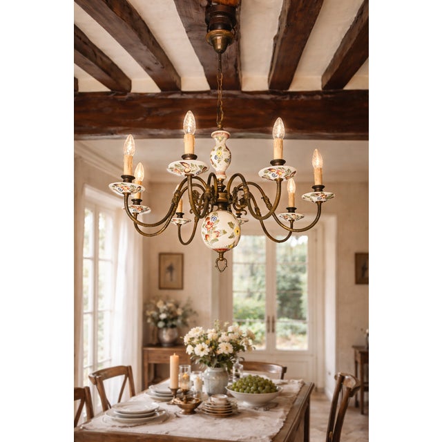 Large decorative French chandelier combining aged brass and hand-painted porcelain. Eight scrolling arms decorated with...