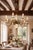 Large decorative French chandelier combining aged brass and hand-painted porcelain. Eight scrolling arms decorated with...