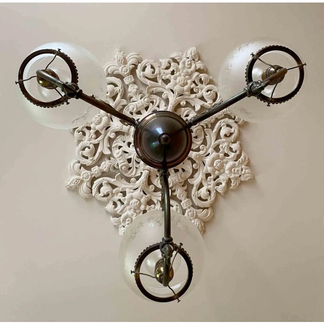 Antique Victorian brass three arm converted gas chandelier with etched glass shades. Brass retains the old patina which...