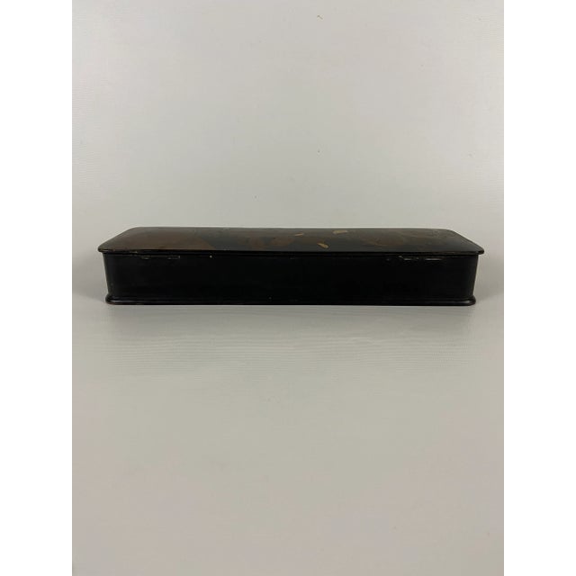 Rectangular Japanese black lacquered box with hinged lid and hand painted decoration of figures and objects.