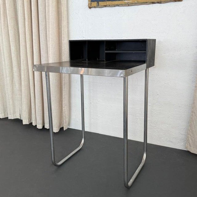 This 1930s modernist black writing desk in the manner of Marcel Breuer emphasizes classic Bauhaus elements maximizing...