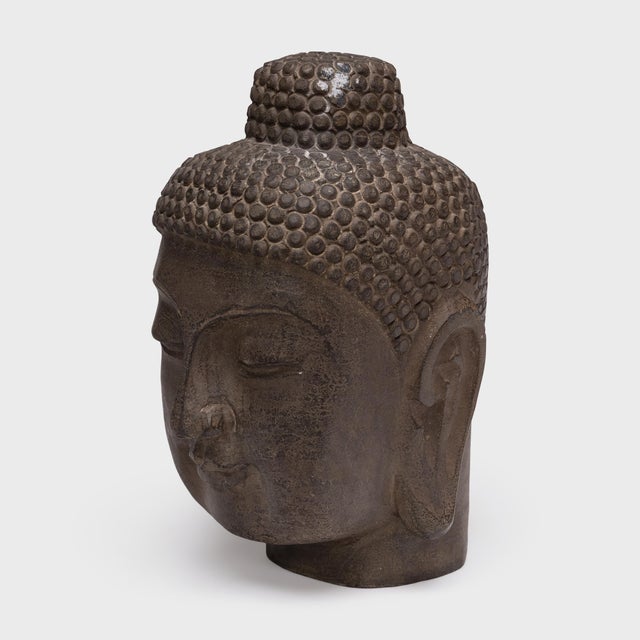 With closed eyes and a gentle expression, this large stone Buddha head brings calm and serenity to its surroundings. The...