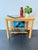 This vintage wooden side table with integrated magazine rack reflects a clean mid-century modern style, combining...