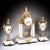 A refined French mantel clock garniture set, dating to the 19th century, executed in gilt bronze and white stone. The...