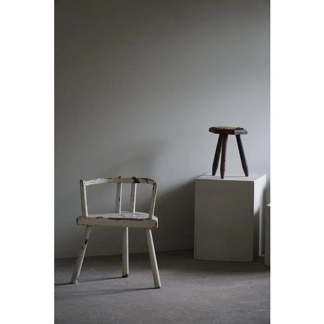 A decorative antique tripod armchair with interesting shapes. A rare decorative object made in wood and painted white....