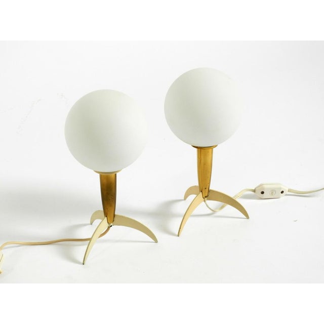 Two beautiful, original mid-century modern table lamps in a rocket shape. Both lamps have glass globe shades. great,...