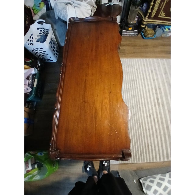 Elegant vintage writing desk crafted in the classic Queen Anne style, featuring a beautifully curved serpentine front and...