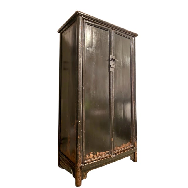 This elegant Chinese locking cabinet from the Qing dynasty follows the simplistic and classic style of the Ming period. An...