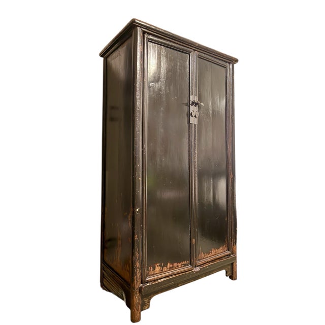 This elegant Chinese locking cabinet from the Qing dynasty follows the simplistic and classic style of the Ming period. An...