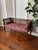This bench/settee has a cane back and cane side panels with a walnut tone glaze over solid wood with speckled patina -...
