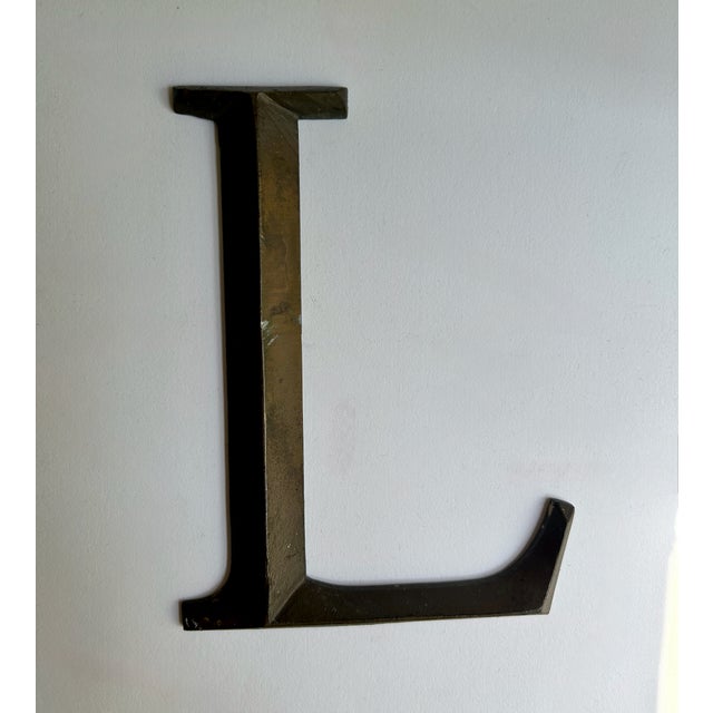 Early 20th Century patinated Cast Bronze or Brass Letter "L" Indoor / Outdoor Wall Signage. Accent. Featuring a sturdy,...