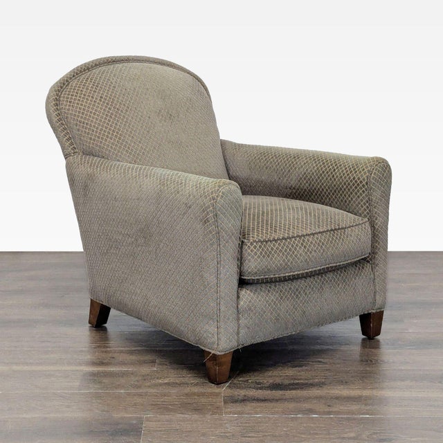 Comfortable lounge chair from Crate & Barrel with a classic design. Features soft, patterned upholstery in neutral tones...
