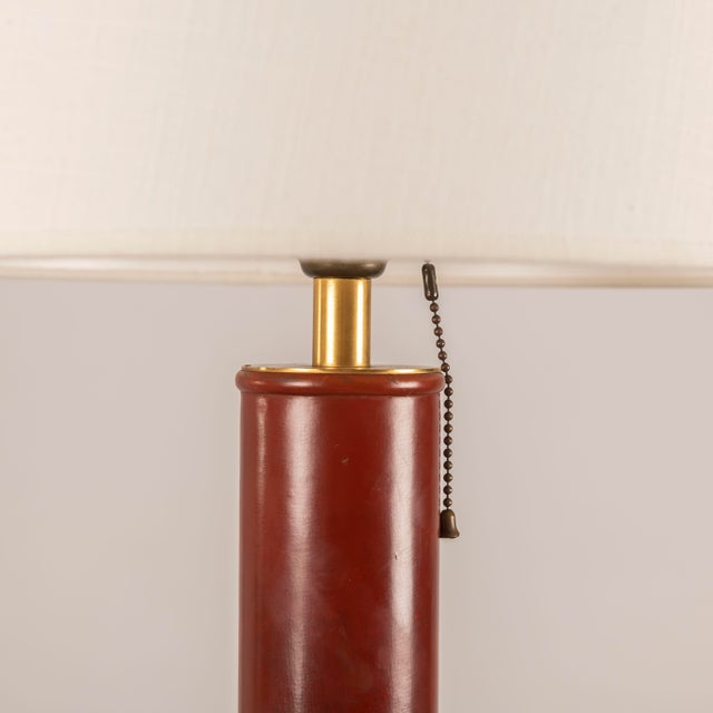 An exquisite table lamp in stitched burgundy leather, attributed to Paul Dupré-Lafon for Hermès, made around 1940 and...