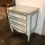 3 drawer night stand with a lightly distressed blue finish accented with aged silver leaf featuring raised panels and...