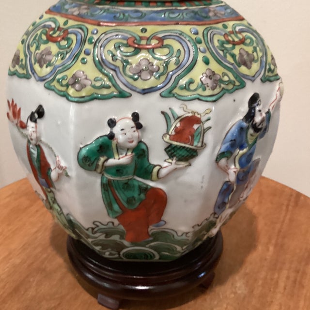 This antique Chinese porcelain ginger jar features a unique design with molded raised eight immortals, showcasing...