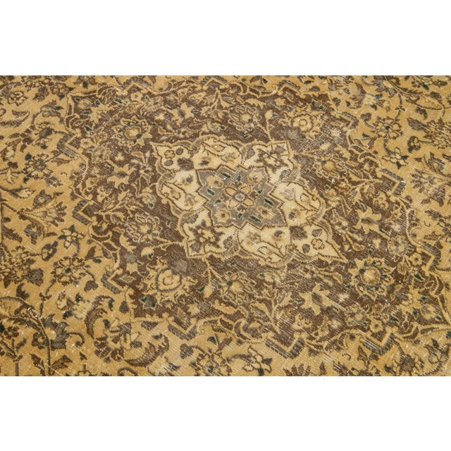 Beautiful antique Persian Tabriz hand-knotted wool rug with an ivory field. This piece has brown frame accents in an all-...
