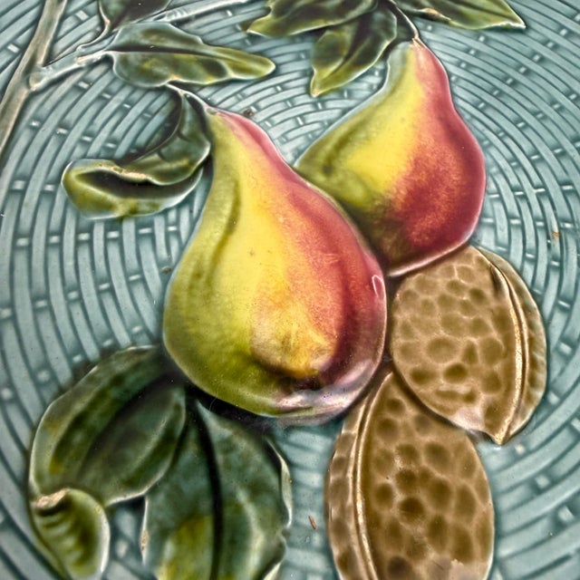 A beautifully modeled German majolica plate by Georg Schmider of Zell, featuring a raised basketweave ground and a central...