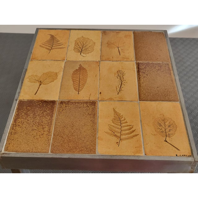 Discover this authentic "Herbarium" coffee table by Roger Capron, a true masterpiece of French ceramic design that evokes...