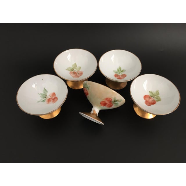 Vintage set of 5 porcelain footed sherbet cups with hand painted cherries or cranberries motifs and gold accents. Bottom...