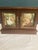 A beautiful vintage finds wooden jewelry box featuring double doors with painted romantic scene panels and ornate brass-...