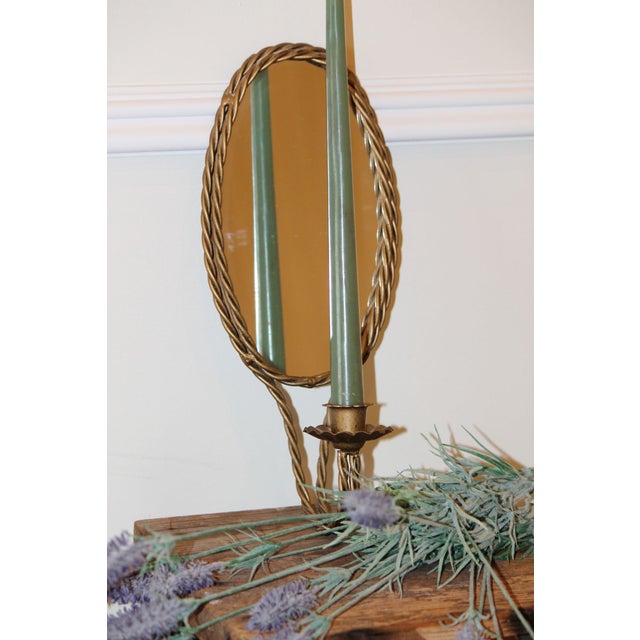 This is an excellent example of vintage! A mirrored candle sconce with brass roping, it's in excellent condition with no...