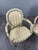 An elegant pair of Louis XVI style medallion armchairs with a matching footstool. The armchairs rest on fluted, tapered...