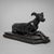 Small iron sculpture of a reclining greyhound with elegantly crossed front paws and raised head. Finely detailed,...