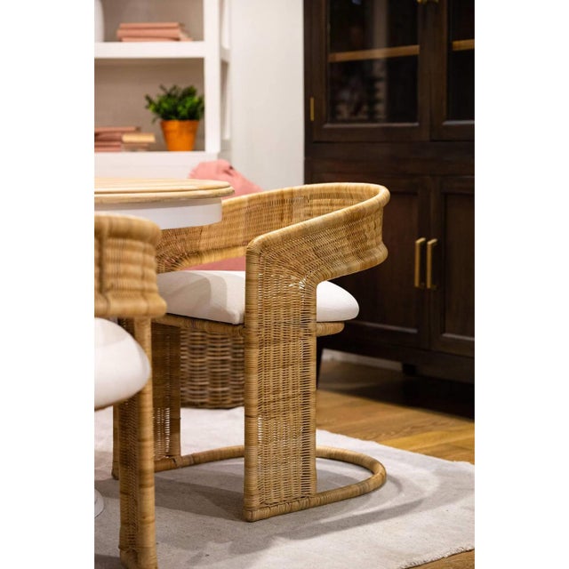 The rattan dining chair adds a soft, sculptural look and natural texture to modern dining or accent spaces. Its curved...