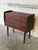 This compact chest features a clean rectangular silhouette elevated on elegantly tapered legs. The front is fitted with...