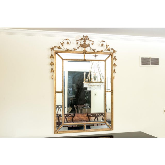 Monumental Louis XVI Style Giltwood and Beveled Wall Mirror by Friedman Brothers Elevate your interior design with this...