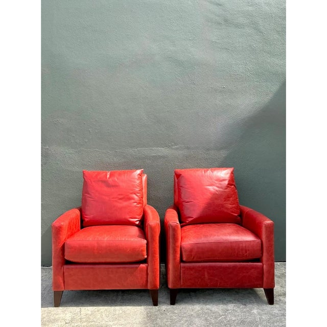 This pair of club chairs presents a clean, tailored silhouette, each featuring a straight, slightly angled back that...